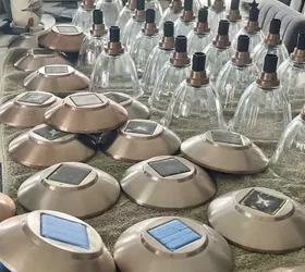 the best way to restore outdoor solar pathway lights, Bunches of glass globes and light covers lined up in an organized assembly line in order to spray paint them